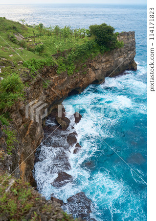 Cinematic aerial landscape shots of the beautiful island of Nusa Penida. Huge cliffs by the shoreline and hidden dream beaches with clear water and foaming wave. Cinematic aerial landscape shots of the beautiful island of Nusa Penida. Huge cliffs by the shoreline and hidden dream beaches with clear water and foaming wave. 114171823