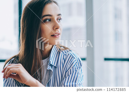 Dreamy lady looking away in office Dreamy lady looking away in office 114172885