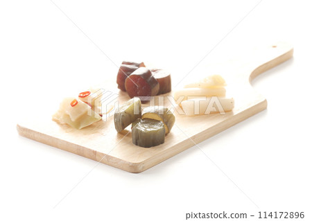 Pickles from Okabe-cho, Fukaya City: green onions, cucumbers, and zha cai on a chopping board Pickles from Okabe-cho, Fukaya City: green onions, cucumbers, and zha cai on a chopping board 114172896