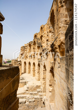 Stone walls with arched passageways of El Jem Amphitheatre, Tunisia 114174547
