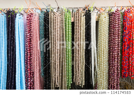Beads from various gemstones on the showcase of jewelry store Beads from various gemstones on the showcase of jewelry store 114174583