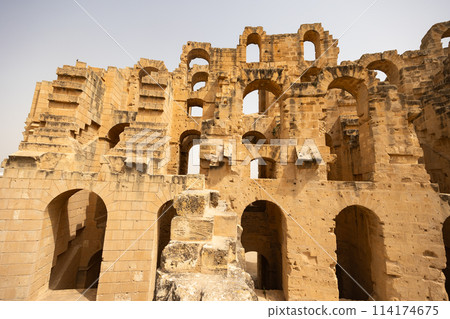 Arches in the exterior walls of Roman amphitheatre in El Jem, Tunisia 114174675