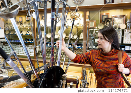 Traveling woman choosing steel souvenirs at Toledo 114174771