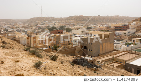 Sun-drenched Ghomrassen cityscape with modern and ancient buildings Sun-drenched Ghomrassen cityscape with modern and ancient buildings 114174899