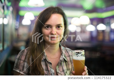 girl in bar with beer 114175322