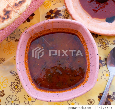Hearty Tunisian soup Chorba Frik in ceramic plate 114175323