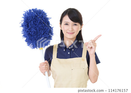 A woman in an apron holding a mop A woman in an apron holding a mop 114176157