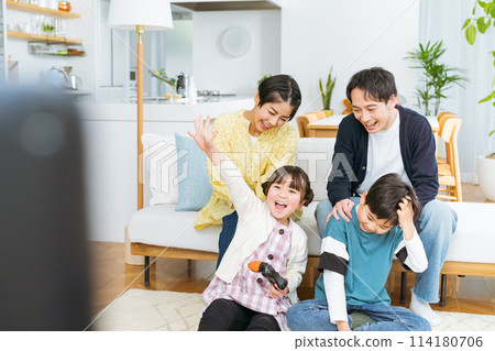 Family playing games in the living room Family playing games in the living room 114180706