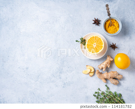 Flat lay from ingredients for a ayurvedic drink. Turmeric powder, ginger, thyme, star anise Flat lay from ingredients for a ayurvedic drink. Turmeric powder, ginger, thyme, star anise 114181782