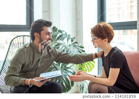 Therapist cheering up his extremely depressed patient 114181859