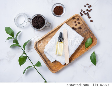 Flat lay with natural ingredients for home body coffee scrub with coffee beans, towel Flat lay with natural ingredients for home body coffee scrub with coffee beans, towel 114182074