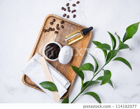 Flat lay with natural ingredients for home body coffee scrub with coffee beans and olive oil Flat lay with natural ingredients for home body coffee scrub with coffee beans and olive oil 114182077