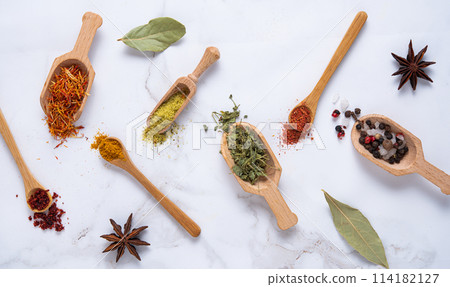 Various wooden spoons of spices on marble background Various wooden spoons of spices on marble background 114182127