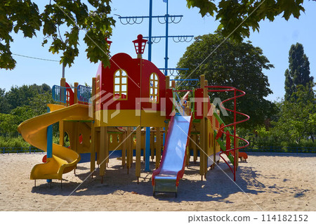 Summer spring children's playground with painted toy slide in park Summer spring children's playground with painted toy slide in park 114182152