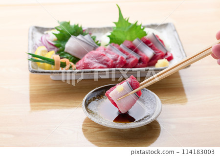 Minke whale meat and skin sashimi dipped in soy sauce Minke whale meat and skin sashimi dipped in soy sauce 114183003