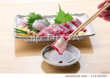 Minke whale meat and skin sashimi dipped in soy sauce Minke whale meat and skin sashimi dipped in soy sauce 114183007