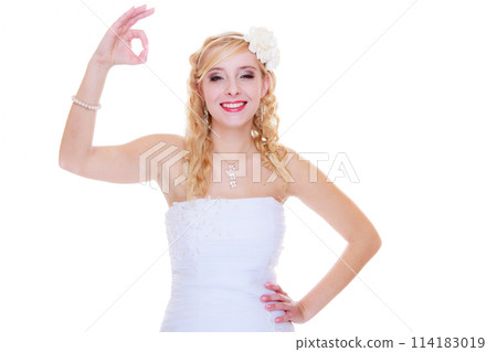 Happy bride in white dress showing a ok sign Happy bride in white dress showing a ok sign 114183019