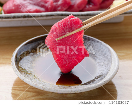 Minke whale meat and skin sashimi dipped in soy sauce 114183027
