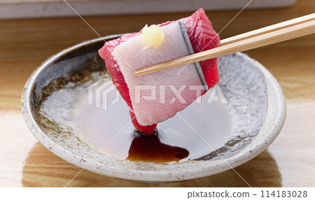 Minke whale meat and skin sashimi dipped in soy sauce 114183028