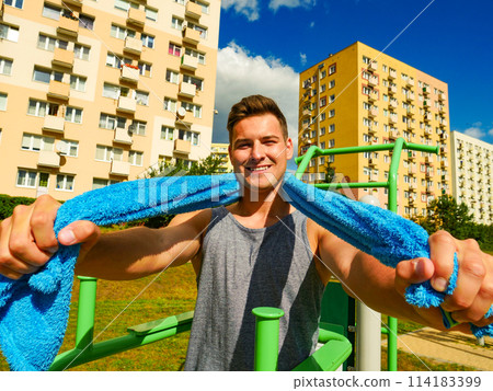 Young man relaxing after outdoor workout Young man relaxing after outdoor workout 114183399