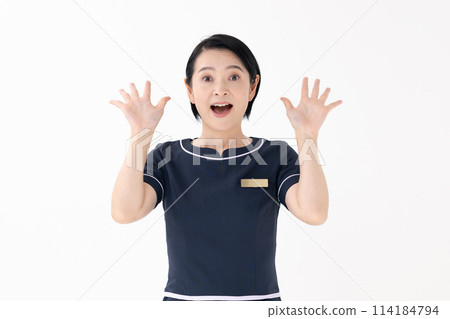 Middle-aged woman, esthetician, uniform, surprised Middle-aged woman, esthetician, uniform, surprised 114184794