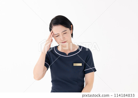 Middle-aged woman, esthetician, uniform, headache Middle-aged woman, esthetician, uniform, headache 114184833