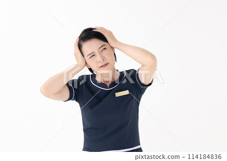 Middle-aged woman, esthetician, uniform, headache Middle-aged woman, esthetician, uniform, headache 114184836