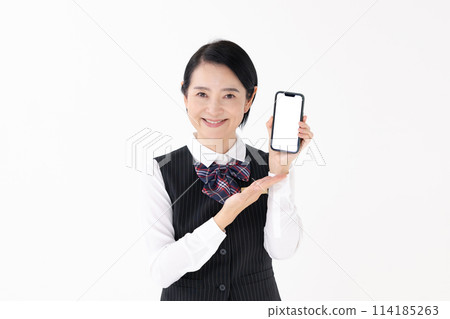 Middle-aged woman, uniform, smartphone Middle-aged woman, uniform, smartphone 114185263