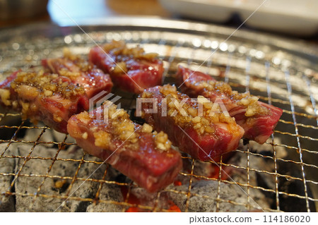 Thick beef grilled directly on a charcoal grill 114186020