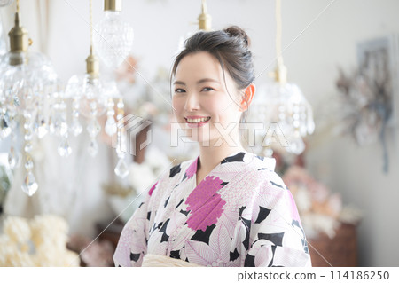 A young woman wearing a yukata with a beautiful sparkling background A young woman wearing a yukata with a beautiful sparkling background 114186250