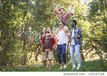 Best multiracial friends hanging out together and walking in park in summer day. Best multiracial friends hanging out together and walking in park in summer day. 114187186