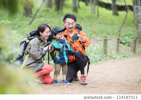Family enjoying outdoor adventures such as mountain climbing, hiking, trekking, etc. Photography, Family enjoying selfies 114187311