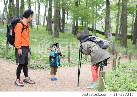 Family enjoying outdoor adventures such as mountain climbing, hiking, and trekking. Photo shoot 114187315