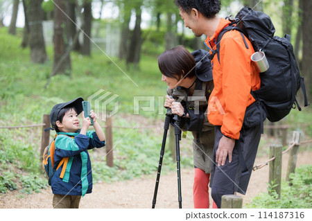 Family enjoying outdoor adventures such as mountain climbing, hiking, and trekking. Photo shoot 114187316