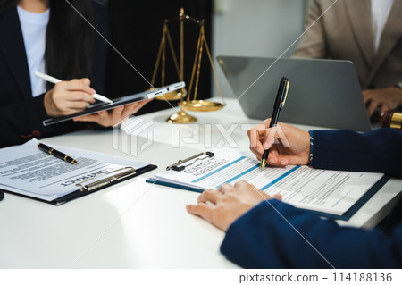 Business people and lawyers discussing contract papers sitting in the table at office in the morning. concepts of law, advice, legal services. 114188136