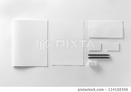 Corporate stationery set mockup. Presentation folder, letterhead, envelope and two business cards at white textured paper background. 114188398