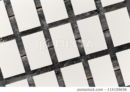 Flatlay mockup of white blank business cards rows at wooden vintage board background. Flatlay mockup of white blank business cards rows at wooden vintage board background. 114189696