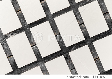 Flatlay mockup of white blank business cards rows at wooden vintage board background. Flatlay mockup of white blank business cards rows at wooden vintage board background. 114189700