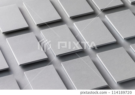 Mockup of vertical business cards stacks arranged in rows at grey textured paper background. 114189720