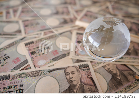 A large number of 10,000 yen bills and a glass globe 114189752