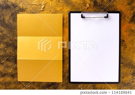 Top view mockup of blank golden foil corporate stationery set of letterhead, folded brochure and holder at golden textured background. 114189841