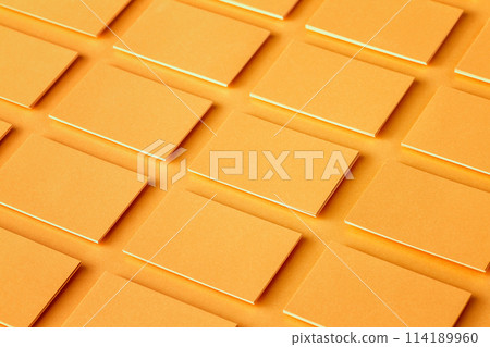 Mockup of horizontal golden business cards stacks arranged in rows at textured paper background. Mockup of horizontal golden business cards stacks arranged in rows at textured paper background. 114189960