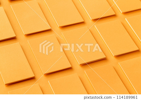 Mockup of vertical golden business cards stacks arranged in rows at textured paper background. 114189961