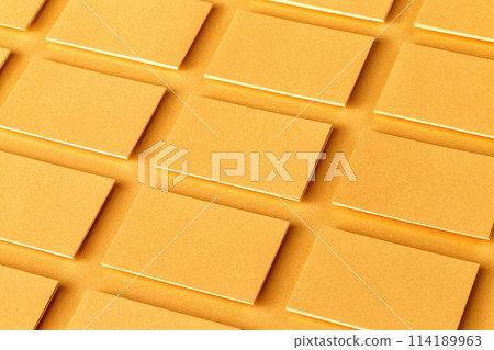Mockup of horizontal golden business cards stacks arranged in rows at textured paper background. 114189963