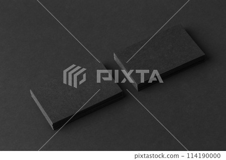 Mockup of two blank business cards stacks at black textured background. 114190000