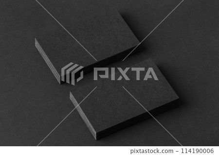Mockup of two blank business cards stacks at black textured background. 114190006