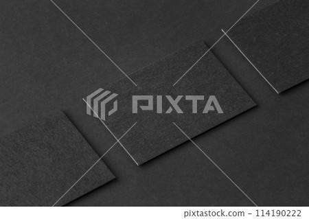 Mockup of three horizontal business cards at black textured paper background. Mockup of three horizontal business cards at black textured paper background. 114190222