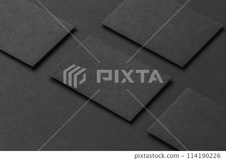 Mockup of four black business cards arranged in rows at black paper background. Mockup of four black business cards arranged in rows at black paper background. 114190226