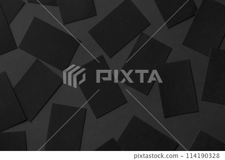 Top view mockup of horizontal business cards scattered at black textured paper background. Top view mockup of horizontal business cards scattered at black textured paper background. 114190328