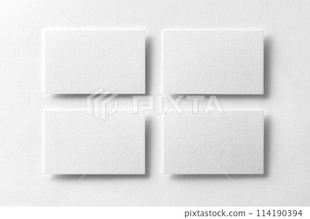 Mockup of four white business cards arranged in rows at white design paper background. 114190394
